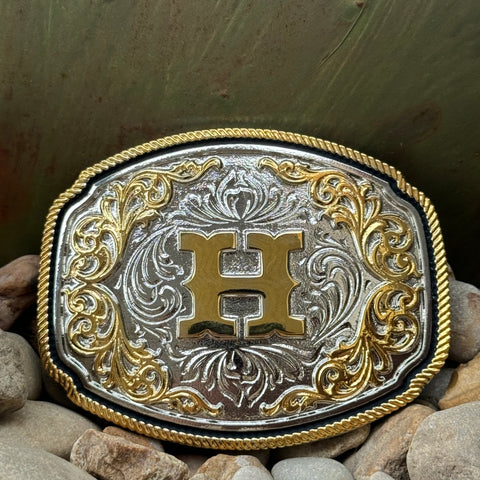 Montana Silversmiths Western Belt Buckle in silver and gold, featuring intricate engravings and a prominent 'H' initial - A1047H. Available at Blair's Western Wear, Marble Falls, TX.