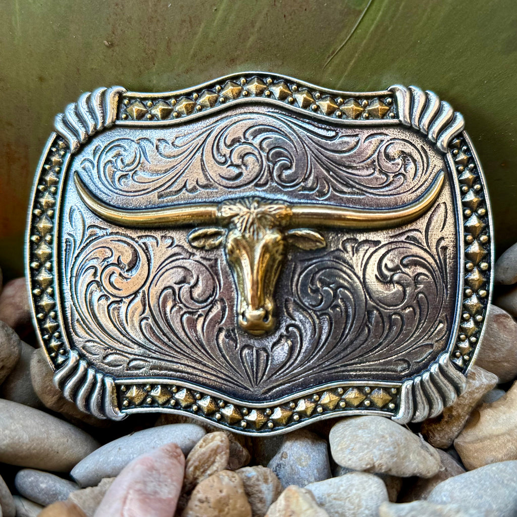 Montana Silversmiths belt buckle Longhorn Legacy two-tone buckle in silver and gold, sculpted gold-tone longhorn centerpiece, with intricate bright-cut Western scroll engraving - A1072P. Available at Blair's Western Wear, Marble Falls, TX.