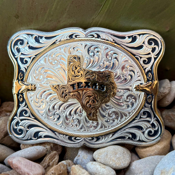 Montana Silversmiths belt buckle scalloped Texas buckle in silver and gold, hand-engraved bright silver finish with deep black antiqued accents, with sculpted gold-tone Texas state centerpiece featuring raised TEXAS lettering - 55610-610TX. Available at Blair's Western Wear, Marble Falls, TX.