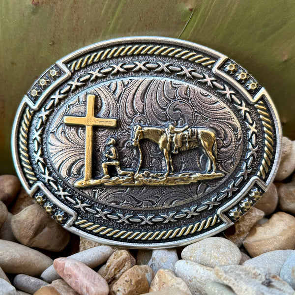 Montana Silversmiths belt buckle Cowboy Prayer buckle in silver and gold, detailed gold-tone cowboy prayer scene with kneeling rider and cross, with antiqued engraved Western scrollwork background - A1074P. Available at Blair's Western Wear, Marble Falls, TX.