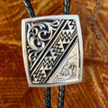 Montana Silversmiths Bolo Tie Silver Aztec in silver, engraved silver-tone pendant with bold Aztec-inspired geometric detailing, with black braided leather cord for durable all-day wear - BT6064. Available at Blair's Western Wear, Marble Falls, TX.