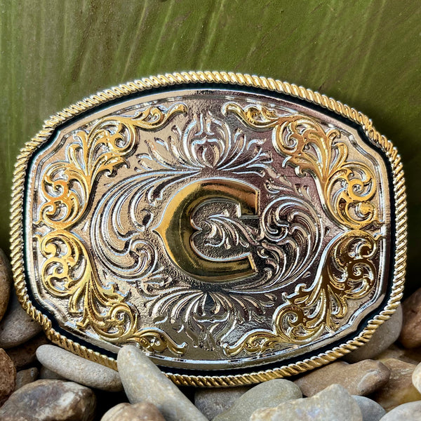 Montana Silversmiths Buckle Silver C in silver, detailed with intricate filigree engravings and a prominent golden 'C' - A1047C. Available at Blair's Western Wear, Marble Falls, TX.