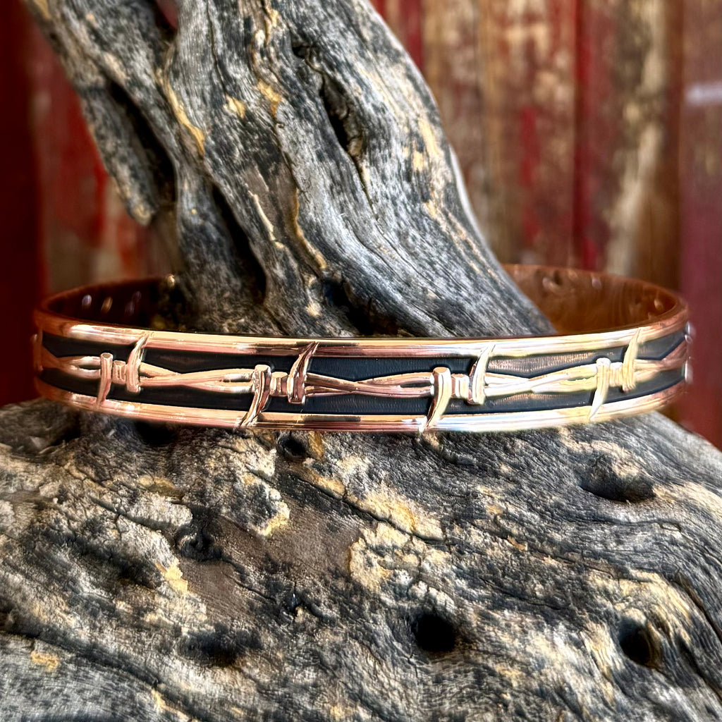 Montana Silversmiths cuff barbed wire bracelet in copper, finished in a rich copper tone with raised barbed wire overlay and dark contrasting inlay for bold Western style - BC6278RG. Available at Blair's Western Wear, Marble Falls, TX.