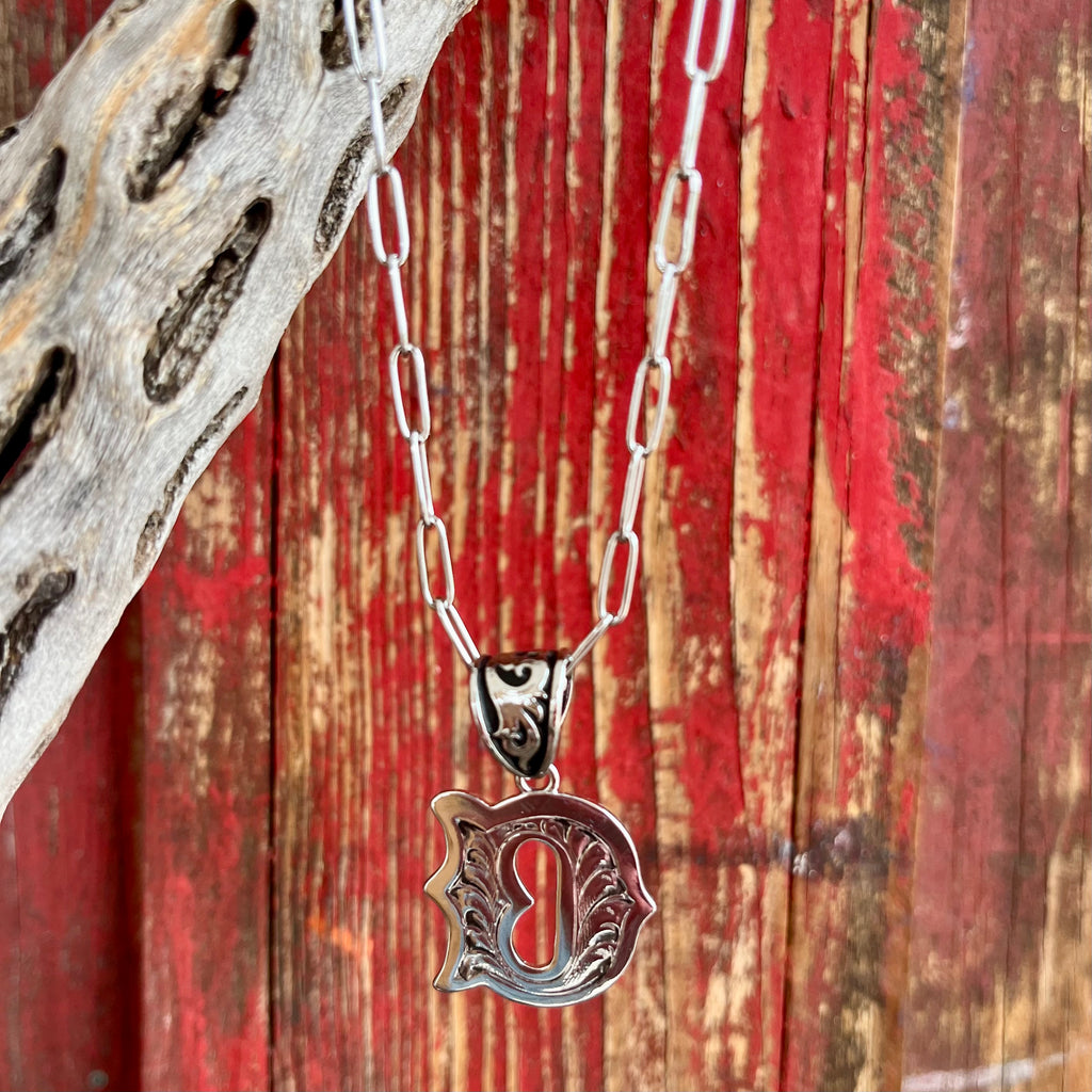 Montana Silversmiths Initial Necklace featuring an intricately engraved 'D' pendant in silver tone, with an 18-inch adjustable paperclip chain and tarnish-resistant finish - NC6096D. Available at Blair's Western Wear, Marble Falls, TX.