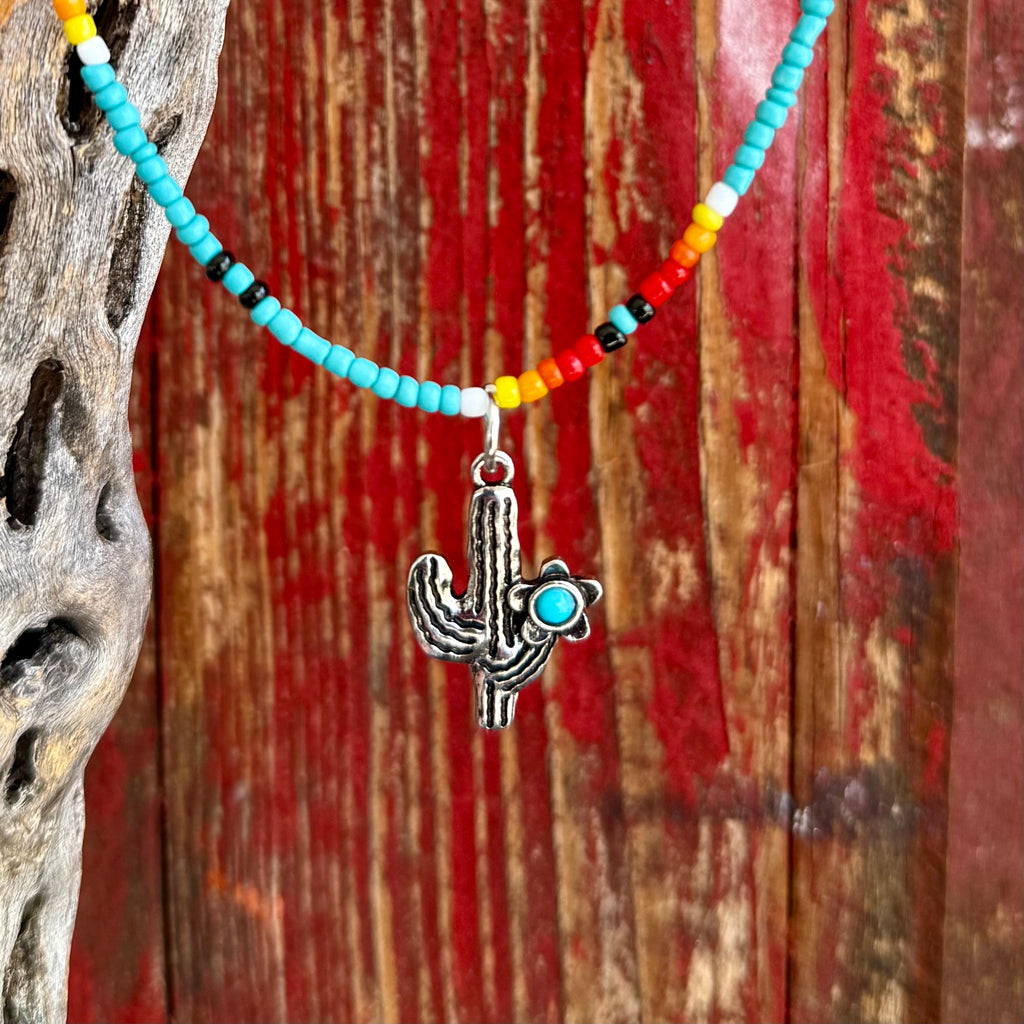 Montana Silversmiths beaded necklace with cactus charm in turquoise, multicolor seed bead design for lightweight comfort, with silver-tone cactus pendant accented by a turquoise-colored stone – ANC5428. Available at Blair's Western Wear, Marble Falls, TX.