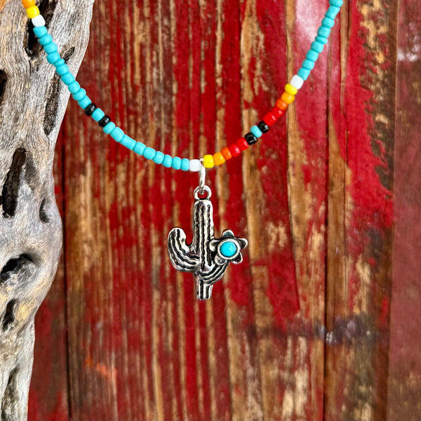 Montana Silversmiths beaded necklace with cactus charm in turquoise, multicolor seed bead design for lightweight comfort, with silver-tone cactus pendant accented by a turquoise-colored stone – ANC5428. Available at Blair's Western Wear, Marble Falls, TX.