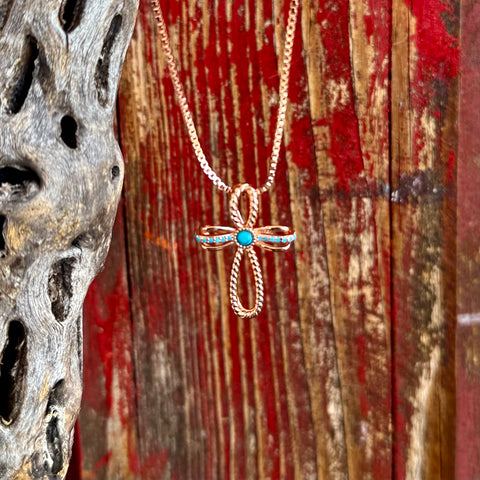 Montana Silversmiths necklace cross pendant in rose gold, rose gold–finished cross pendant that adds warmth and a modern western touch to both everyday and dress outfits, with center turquoise stone creates a bold focal point, delivering vibrant color contrast that stands out against the polished metal - NC6394. Available at Blair's Western Wear, Marble Falls, TX.