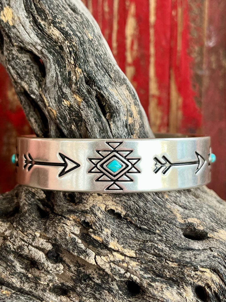 Montana Silversmiths silver-toned adjustable cuff bracelet featuring etched arrow and geometric designs with diamond-shaped turquoise stones - BC5034. Available at Blair's Western Wear, Marble Falls, TX.