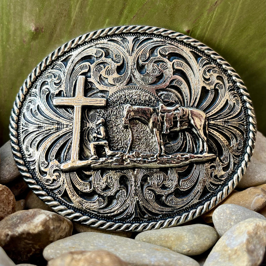 Montana Silversmiths Belt Buckle in silver, featuring intricate designs with a praying cowboy, cross, and horse - 61304M. Available at Blair's Western Wear, Marble Falls, TX.