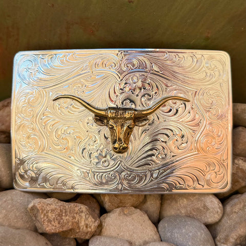 Montana Silversmiths rectangle silver belt buckle with gold longhorn, featuring bright-cut scrollwork, with a standard 1.5-inch belt swivel attachment – 46510-64. Available at Blair's Western Wear, Marble Falls, TX.