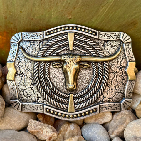 Montana Silversmiths rectangular buckle longhorn design in antique silver and gold, built with a raised longhorn figure, with secure clasp construction – A930. Available at Blair's Western Wear, Marble Falls, TX.