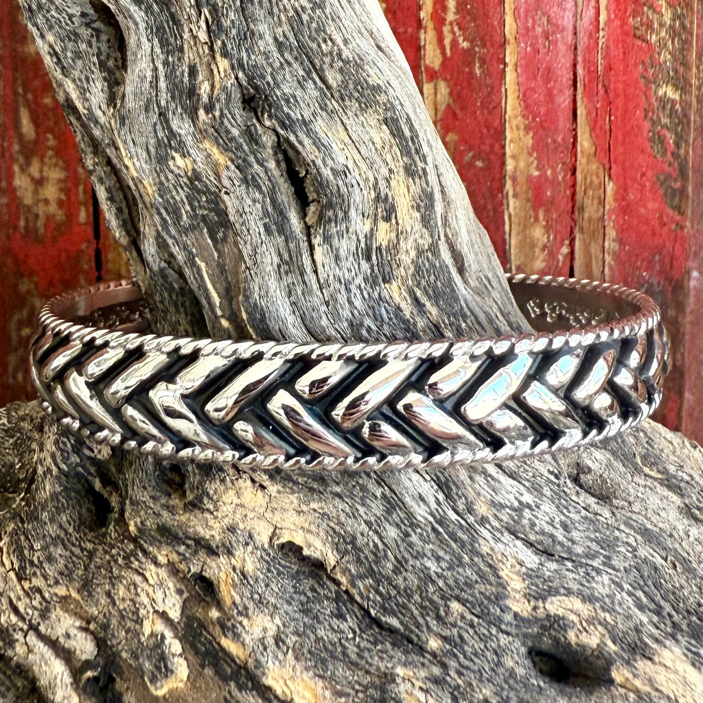 Montana Silversmiths silver cuff bracelet with chevron weave design, polished finish with dark accents, and rope-style edging – BC6284. Available at Blair's Western Wear, Marble Falls, TX.