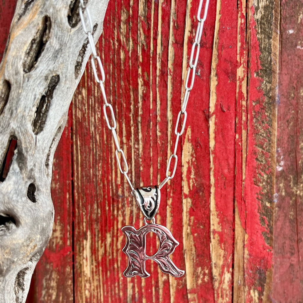 Montana Silversmiths Necklace featuring an intricate silver scroll design in the shape of the letter "R," expertly crafted for durability and lasting shine - NC6096R. Available at Blair's Western Wear, Marble Falls, TX.