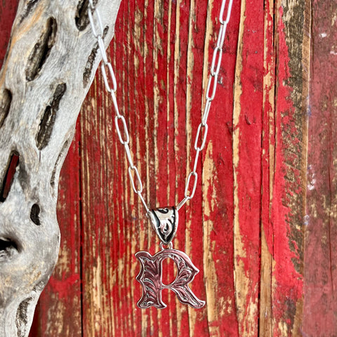 Montana Silversmiths Necklace featuring an intricate silver scroll design in the shape of the letter "R," expertly crafted for durability and lasting shine - NC6096R. Available at Blair's Western Wear, Marble Falls, TX.