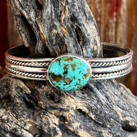 Nizhoni Traders cuff bracelet turquoise sterling silver bracelet in blue, Kingman turquoise centerpiece with natural matrix, with handcrafted sterling silver rope and band detailing - NZCUFFCIRC. Available at Blair's Western Wear, Marble Falls, TX.