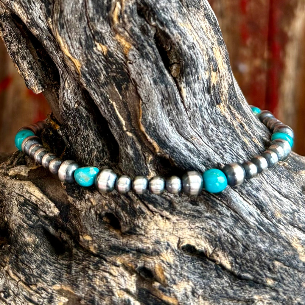 Nizhoni Traders Bracelet Sterling Silver Beaded Bracelet in Turquoise, handcrafted with 3–4mm sterling silver pearl beads for lightweight comfort, with six genuine turquoise accent stones for natural Southwestern color - NZBRPEARLSM. Available at Blair's Western Wear, Marble Falls, TX.
