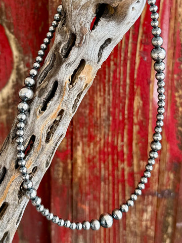 Nizhoni Traders necklace Navajo pearl cluster necklace in silver, graduated Navajo pearl design that creates a balanced, eye-catching silhouette while drawing attention to the neckline, with sterling silver beads with a high-polish finish that reflect light beautifully for a clean, elevated look - NKNAVCLUST. Available at Blair's Western Wear, Marble Falls, TX.