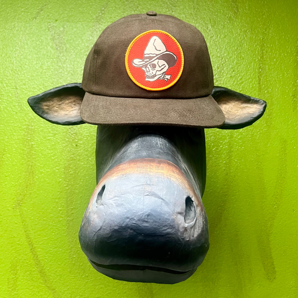 Sendero Cap Cowboy Skull Hat in Chocolate/Orange, structured 5-panel fit with bold embroidered skull patch, with adjustable snapback for all-day comfort - MURIETTA. Available at Blair's Western Wear, Marble Falls, TX.