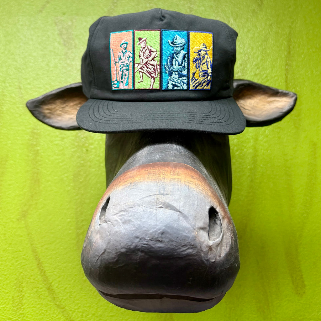 Sendero Cowboy Repeat Pop Art Cap in black, featuring multicolor embroidered cowboy panels, with breathable mesh back and adjustable snapback closure - CAP COWBOY REPEAT. Available at Blair's Western Wear, Marble Falls, TX.