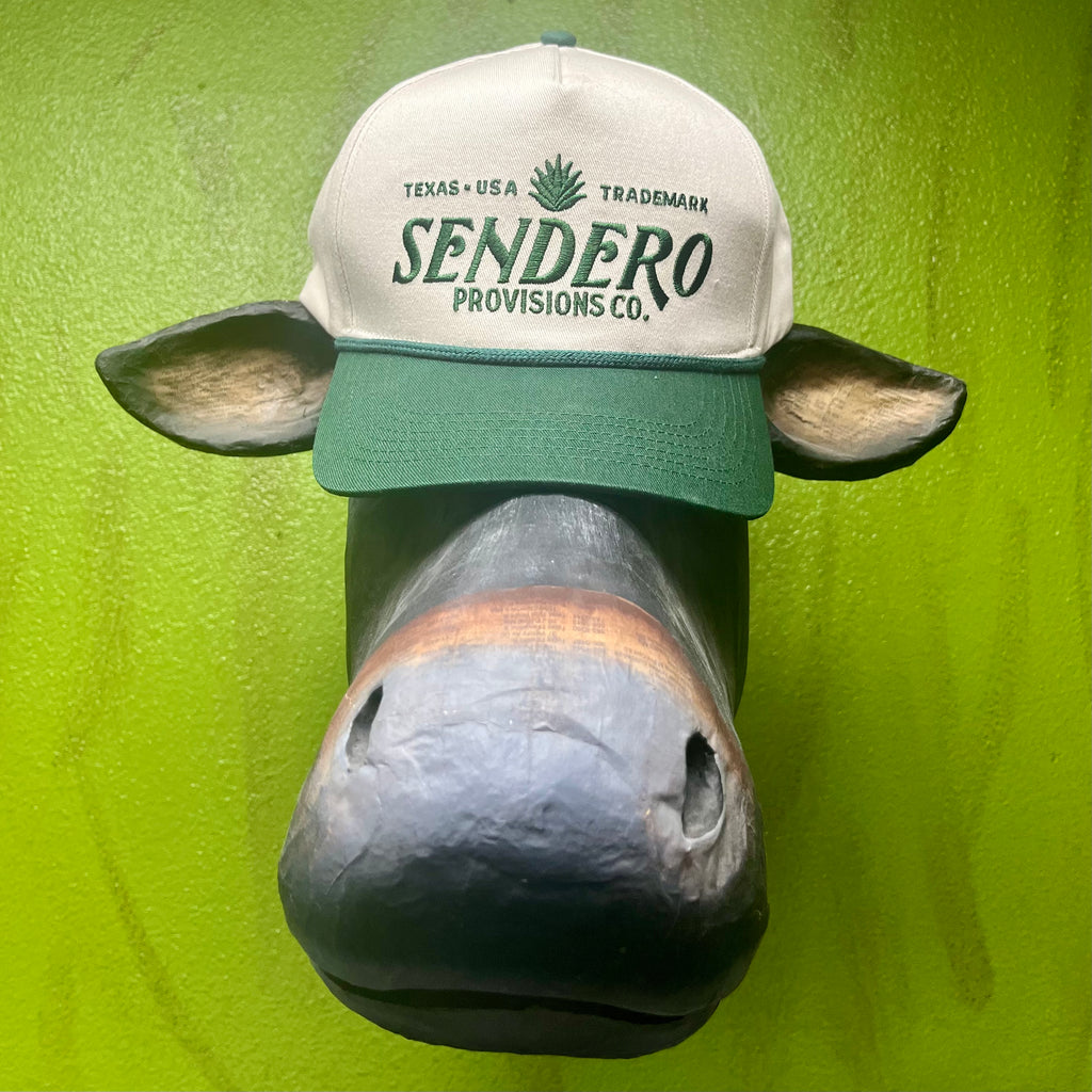 Sendero Provisions Co. Cap Logo Hat in Natural and Hunter Green, durable cotton twill fabric with embroidered logo and adjustable snapback closure - CAP SENDERO LOGO. Available at Blair's Western Wear, Marble Falls, TX.