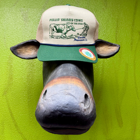Sendero Provisions Co. trucker hat cream/green Pullin’ Skinny Cows design, with breathable mesh back, and adjustable snapback closure - SKINNY COWS. Available at Blair's Western Wear, Marble Falls, TX.