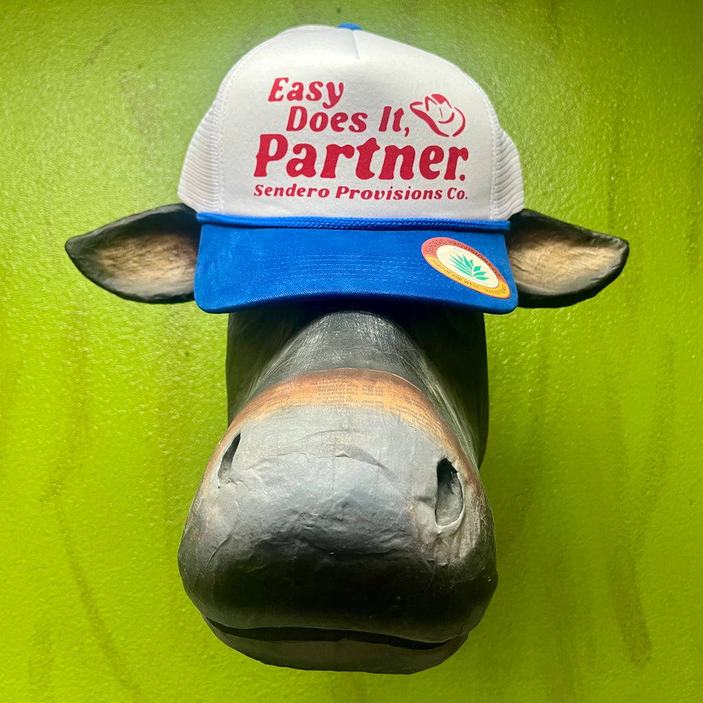 Sendero Provisions Co. Trucker Hat in White/Blue/Red, breathable mesh back for airflow, with structured front and bold red lettering - CAP MESH PARTNER - EASY DOES IT. Available at Blair's Western Wear, Marble Falls, TX.