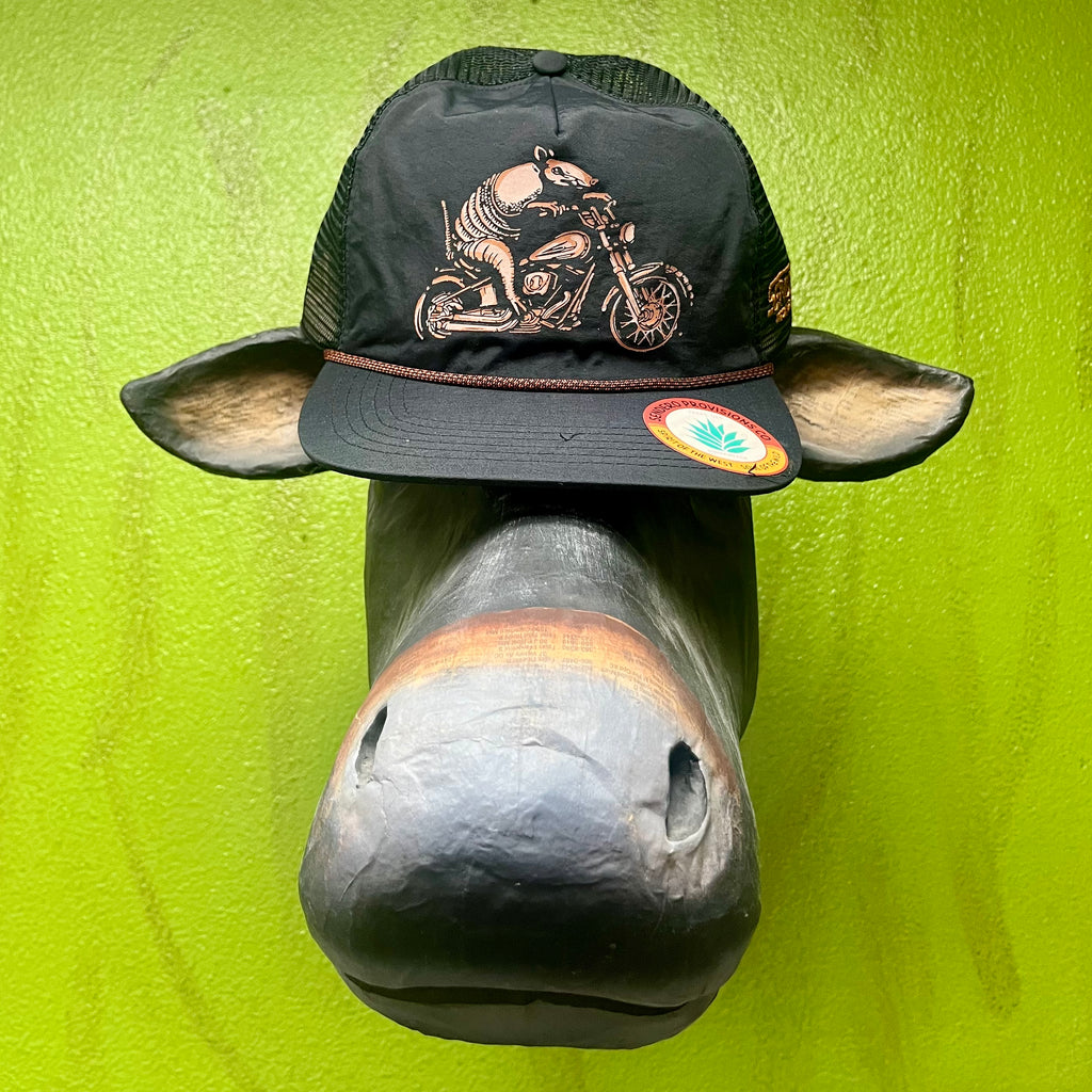 Sendero Trucker Hat Armadillo Motorcycle Cap in Black, features breathable mesh-back for airflow, with bold armadillo motorcycle graphic and curved brim for sun protection - DILLO RIDER. Available at Blair's Western Wear, Marble Falls, TX.