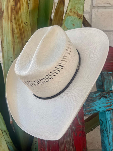 Stetson straw cowboy hat in natural color, 10X plaited weave offering breathable comfort, with a curved 4¼-inch brim and vented crown featuring a slim leather band with logo pin – SSPLAT304281. Available at Blair's Western Wear, Marble Falls, TX.