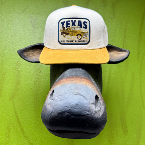Texas Hill Country Provisions cap, trucker-style gold and white Pasture Party Cedar Chopper, featuring a structured wide-rib twill front and breathable mesh back with an adjustable snapback — PASTURE. Available at Blair's Western Wear, Marble Falls, TX.