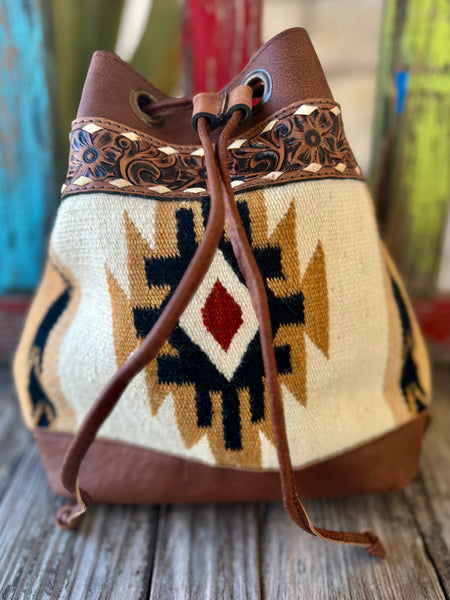 Women’s American Darling blanket leather bucket purse in natural, chocolate, and brick, woven Southwestern textile body for lightweight structure, with hand-tooled leather band and drawstring closure - ADBG862D. Available at Blair's Western Wear, Marble Falls, TX.