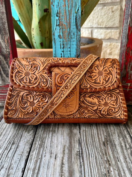 Women’s American Darling clutch tooled leather clutch in tan, hand-tooled floral leather for long-lasting Western style, with secure flap closure and compact 10 x 6 x 1.5 inch size – ADBG1134A. Available at Blair's Western Wear, Marble Falls, TX.