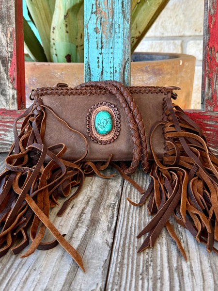 Women’s American Darling Crossbody Fringe Stone Bag in Brown, genuine full-grain leather that develops rich patina over time, with statement turquoise stone centerpiece and long leather fringe detailing - ADBGM277B. Available at Blair's Western Wear, Marble Falls, TX.