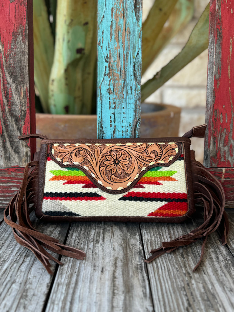 Women’s American Darling Crossbody Serape Fringe Purse in brown leather with red, green, and cream serape pattern, featuring a hand-tooled floral flap and side fringe – ADBGA188P. Available at Blair’s Western Wear, Marble Falls, TX.