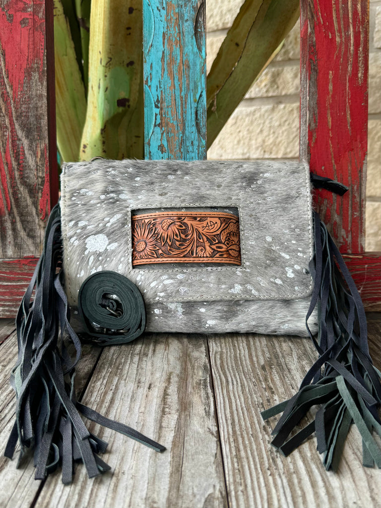 Women’s American Darling hair-on hide fringe crossbody clutch in grey, crafted from genuine hide for long-lasting wear, with an artisan tooled leather inset for added style – ADBG360ACSL. Available at Blair's Western Wear, Marble Falls, TX.