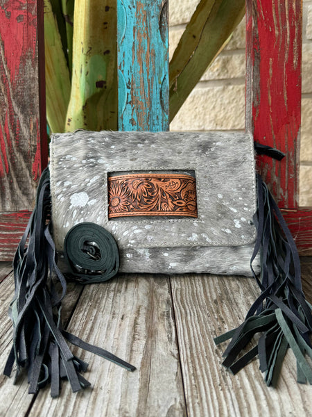 Women’s American Darling hair-on hide fringe crossbody clutch in grey, crafted from genuine hide for long-lasting wear, with an artisan tooled leather inset for added style – ADBG360ACSL. Available at Blair's Western Wear, Marble Falls, TX.