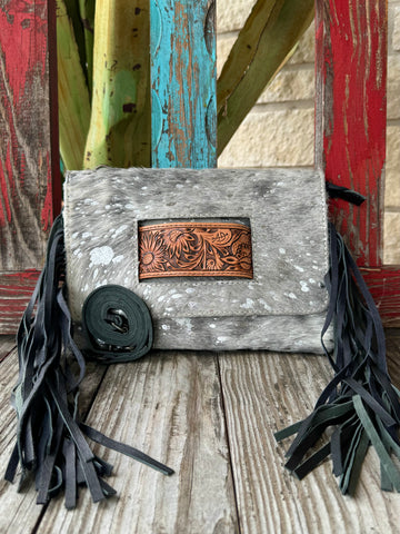 Women’s American Darling hair-on hide fringe crossbody clutch in grey, crafted from genuine hide for long-lasting wear, with an artisan tooled leather inset for added style – ADBG360ACSL. Available at Blair's Western Wear, Marble Falls, TX.