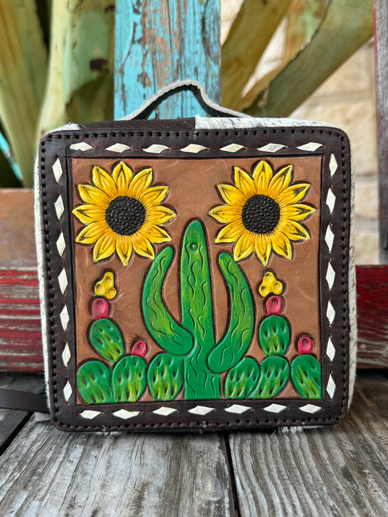 Women’s American Darling jewelry case in genuine hair-on-hide leather with hand-tooled floral detail and dual zipper closure for secure, compact storage – ADBGA311B. Available at Blair’s Western Wear, Marble Falls, TX.