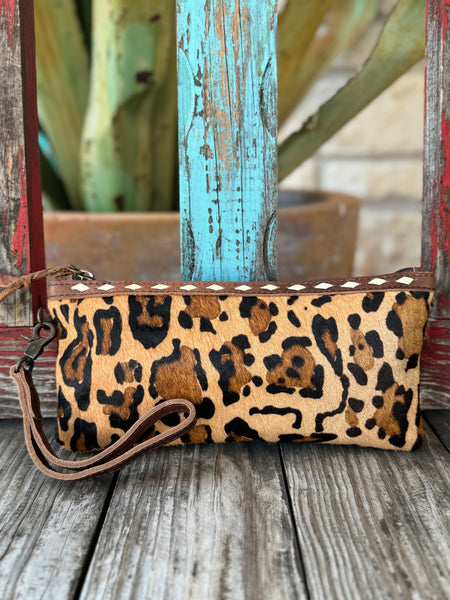 Women’s American Darling hair-on hide leopard wristlet in tan and black, featuring full-grain leather trim and detachable wrist strap – ADBG344AF. Available at Blair’s Western Wear, Marble Falls, TX.