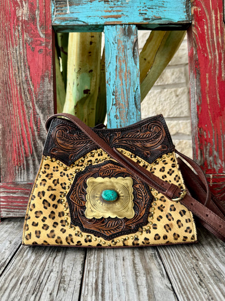 Women’s American Darling leopard print leather crossbody bag in tan and brown with turquoise-center concho and adjustable strap, featuring secure zip closure – ADBGI165C. Available at Blair's Western Wear, Marble Falls, TX.
