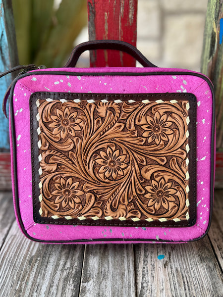 Women’s American Darling makeup case tool hide in hot pink and tan, genuine hair-on hide with hand-tooled floral leather panel, with secure zip-around closure and structured top handle - ADBGA233. Available at Blair's Western Wear, Marble Falls, TX.