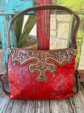 Women's American Darling purse tool hide bag in red hair-on cowhide with hand-tooled leather overlay, featuring antique-finish stud accents and an adjustable leather shoulder strap - ADBG713I. Available at Blair's Western Wear, Marble Falls, TX.
