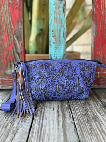 Women’s American Darling tooled leather wristlet in purple, crafted from full-grain leather that softens with use, featuring hand-tooled floral detailing and removable wrist strap with fringe tassel – ADBG1234G. Available at Blair’s Western Wear, Marble Falls, TX.