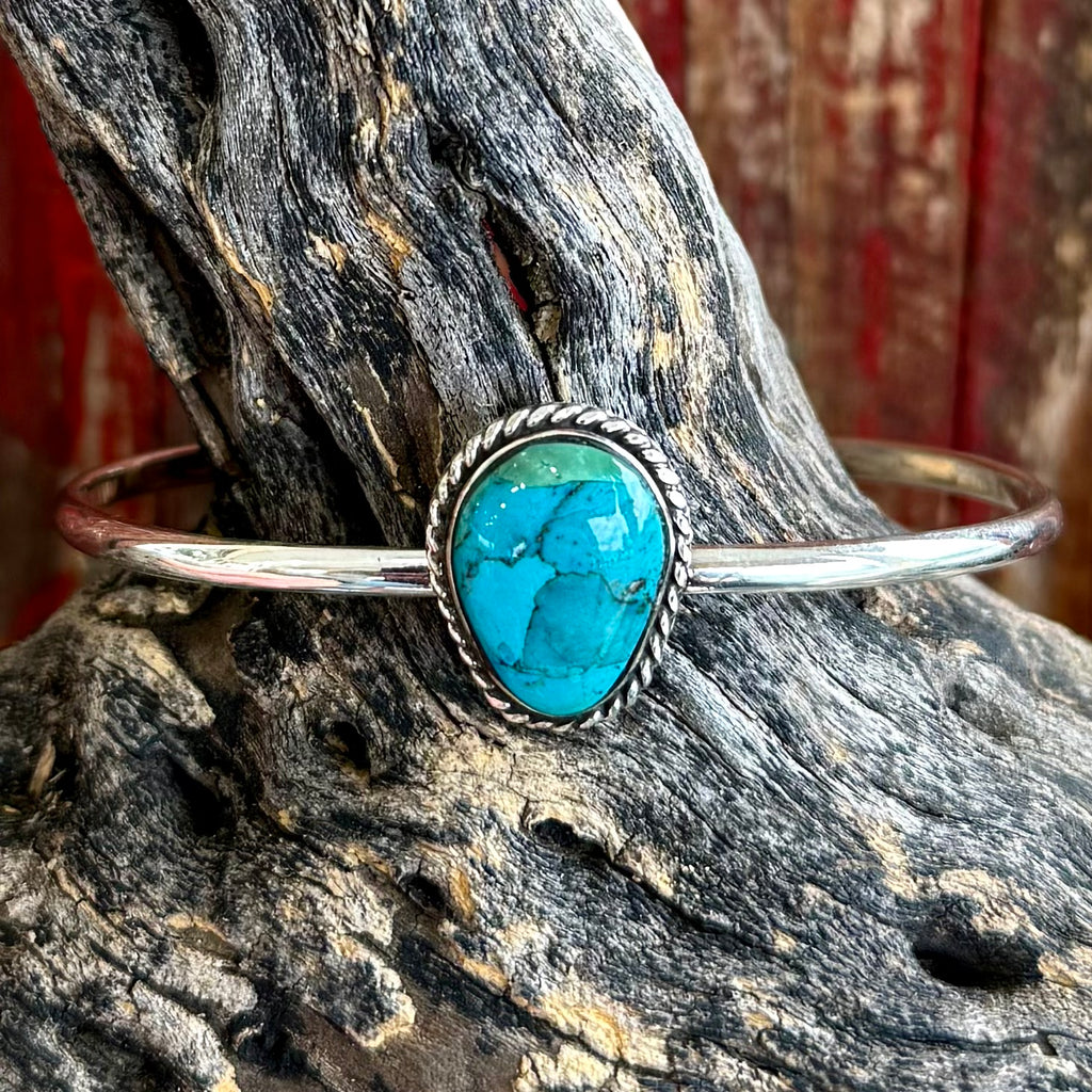 Women’s Boho Sol silver cuff bracelet with teardrop turquoise stone, lightweight silver band, with rope-edge bezel framing — T4123. Available at Blair's Western Wear, Marble Falls, TX.