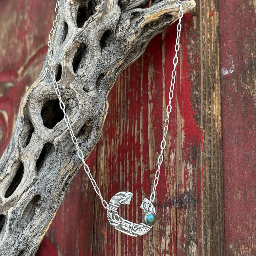 Women’s Boho Sol Necklace in Turquoise/Silver, hand-tooled crescent pendant with floral detailing, with a vibrant turquoise stone inset for a pop of color - T379XSC. Available at Blair's Western Wear, Marble Falls, TX.