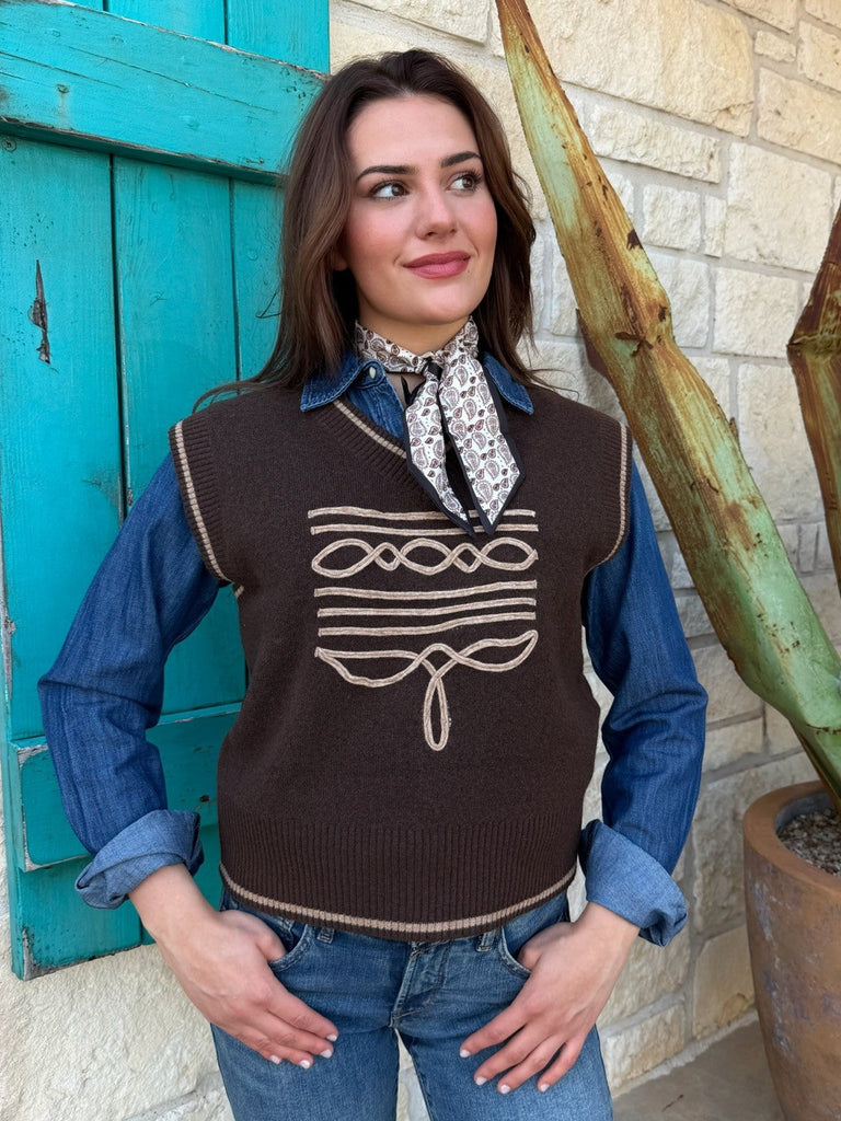 Women's dark brown knit vest with tan bootstitch rope detail on front, layered over denim shirt with paisley wild rag — Blair's Western Wear Marble Falls TX