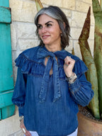 630408 — Women's medium denim blue ruffle yoke tie neck long sleeve blouse with double-tiered ruffle yoke across shoulders, keyhole neckline, long self-tie bow, and blouson sleeves with elasticized cuffs — Blair's Western Wear Marble Falls TX