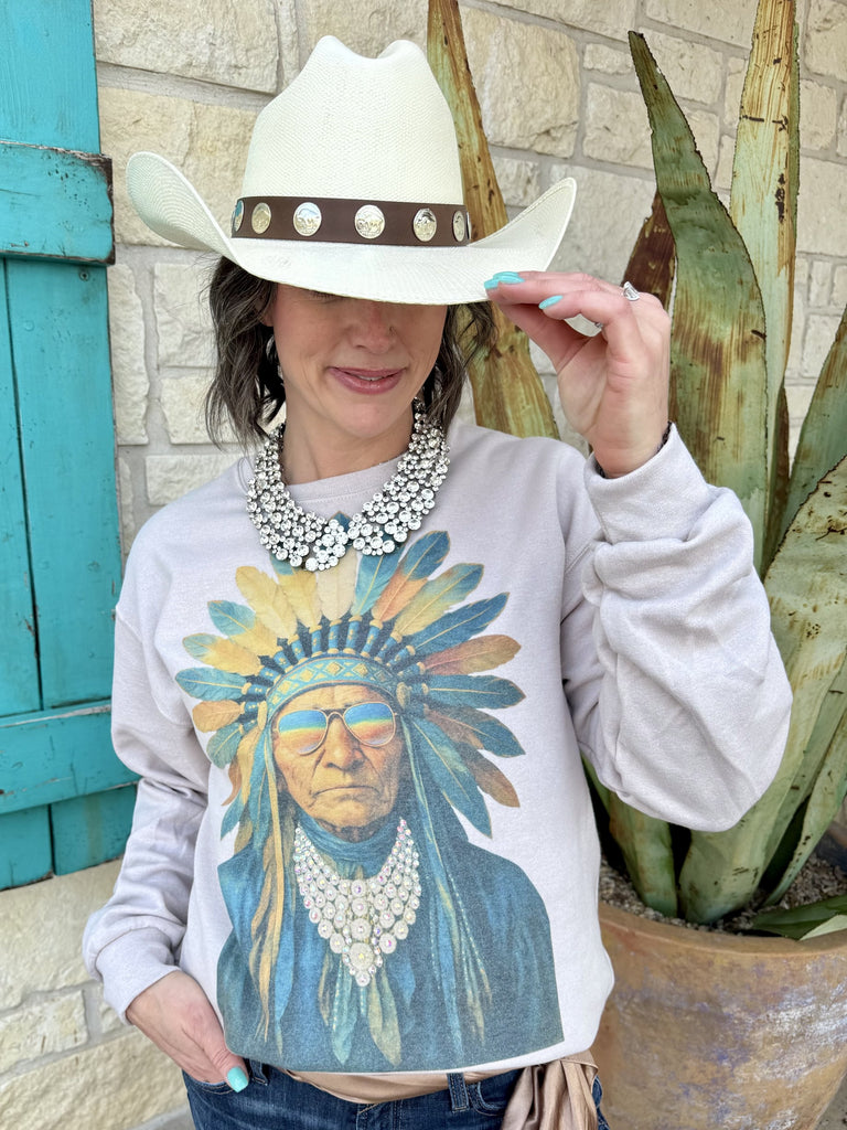 Women’s graphic sweatshirt pullover in light gray, Indian chief headdress print with embellished jeweled necklace and jeweled neckline detail, soft fleece interior. Available at Blair's Western Wear, Marble Falls, TX.