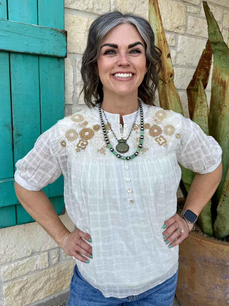 Women’s Ivy Jane blouse embroidered top in ivory, lightweight textured fabric with tan floral embroidery and button-front neckline - Edna. Available at Blair's Western Wear, Marble Falls, TX.