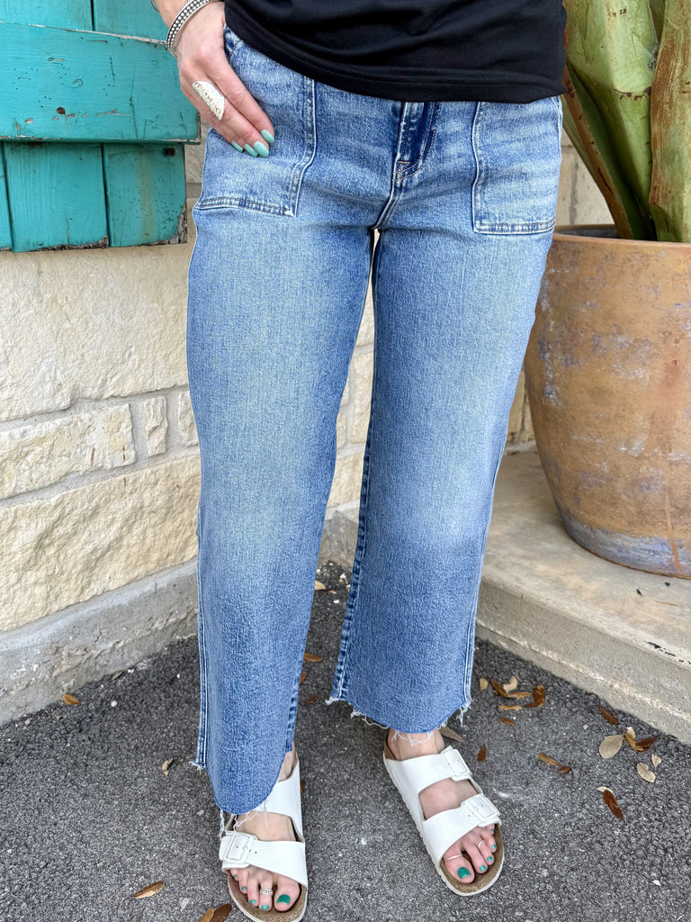 Women’s medium wash cropped straight leg denim jeans with front patch pockets and raw hem - T7243. Available at Blair's Western Wear, Marble Falls, TX.