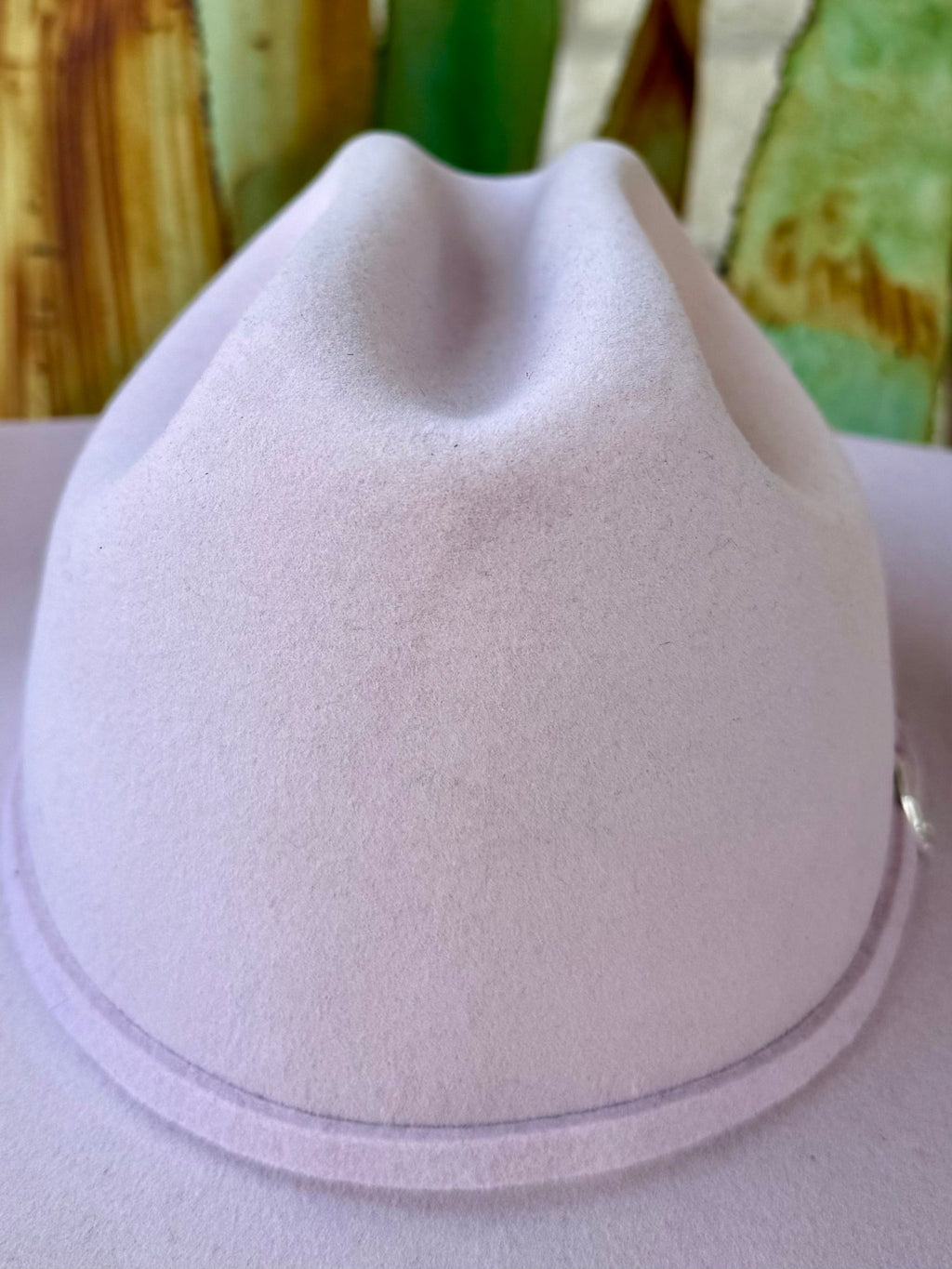 alt text: Light pink felt cowgirl hat showing a rounded crown front, recessed center crease and narrow matching felt band — Blair's Western Wear Marble Falls TX